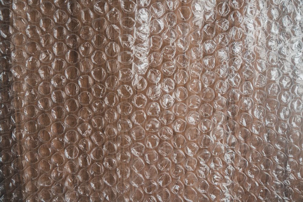 Top view of textured backdrop representing bubble wrap with uneven surface in shiny light